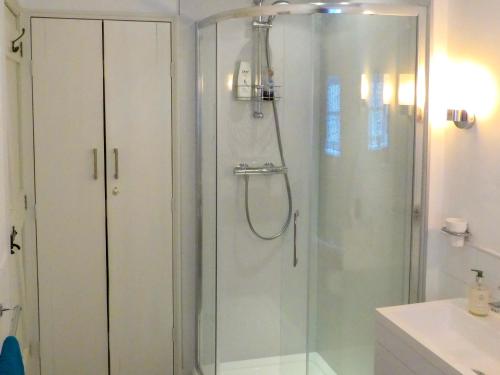 a shower with a glass door in a bathroom at Chapel Cottage in Askham