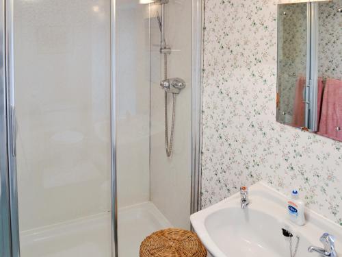 a bathroom with a shower and a sink at White Cottage in Lower Largo