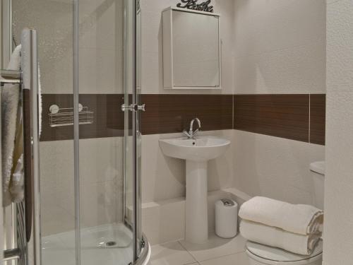 a bathroom with a sink and a toilet and a shower at The Orangery in Bideford
