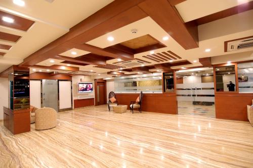 a large lobby with a hard wood floor and chairs at Udman Hotel Haridwar in Haridwār
