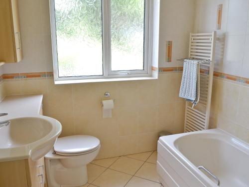 a bathroom with a toilet and a sink and a tub at Fairfield in Barrowford