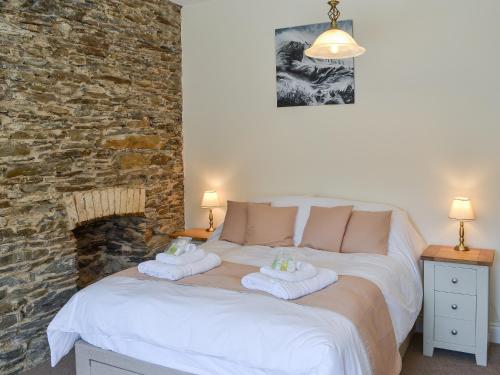 a bedroom with a bed with towels on it at Rosetta Apartments - Ocean Mist in Newquay