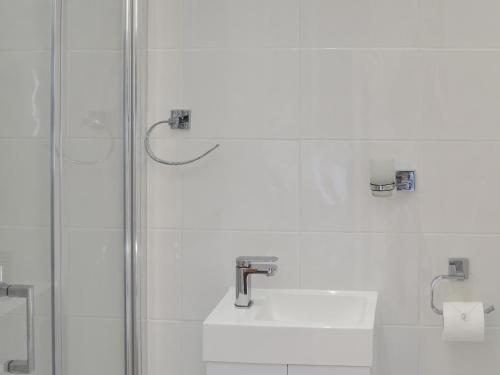 a bathroom with a sink and a shower at Rosetta Apartments - Ocean Mist in Newquay