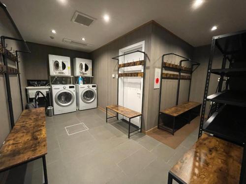 a laundry room with two washing machines and a washer and dryer at Hakobune Niseko - 8-room Chalets & 2-room Apartments in Niseko