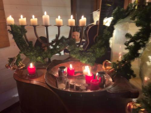 a group of candles on a table in front of a mirror at La Chanterelle - Mountain Lodge in La Côte dʼArbroz
