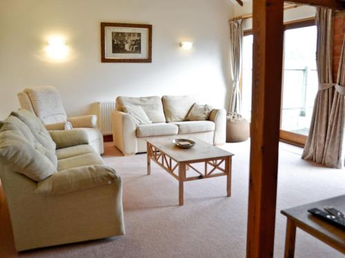 a living room with two couches and a coffee table at Torridge in Great Torrington
