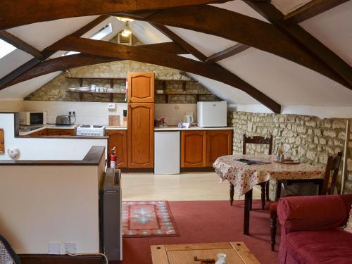 a kitchen and dining room with a table in a room at Weycroft Hall Cottage in Axminster