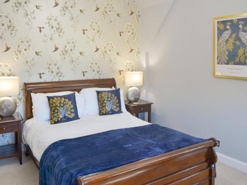 1 dormitorio con 1 cama con 2 mesitas de noche y 2 lámparas en Littlecroft, en Alnmouth