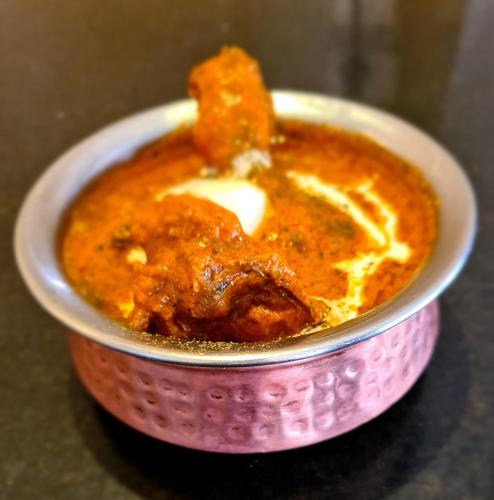 a small bowl of food with a spoon in it at Udman Hotel Haridwar in Haridwār