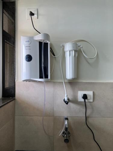 a bathroom with a blow dryer on the wall at 2BHK luxurious beautiful flat near IIM AIIMS in Nagpur