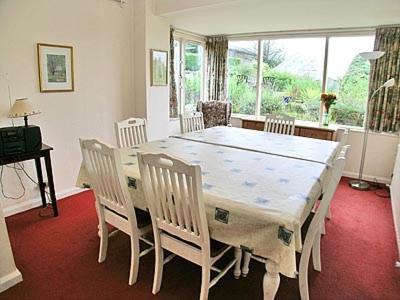a dining room with a white table and chairs at Drumlin in Hawkshead
