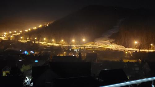 a city at night with snow and lights at Willa Kania in Szczawnica