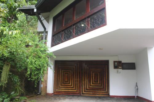 a wooden door on the side of a house at Lazy Bear Best Hostel in Kandy in Kandy