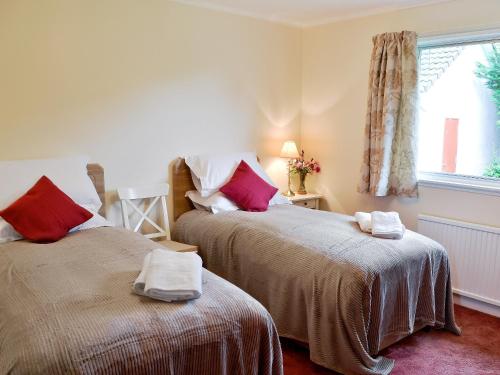 two beds sitting next to each other in a room at Bydand in Walkerburn