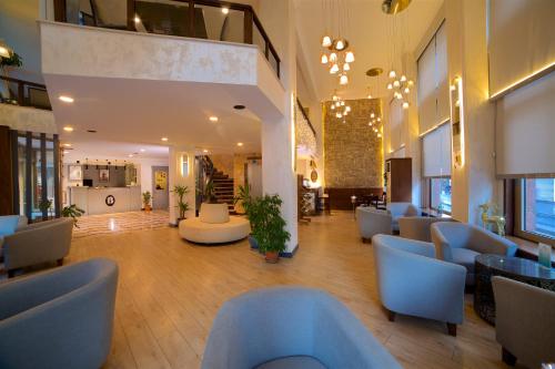 a lobby with blue chairs and tables in a building at Barin Hotel in Istanbul