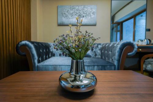 a vase of flowers sitting on a table at Bushi Resort & SPA in Skopje