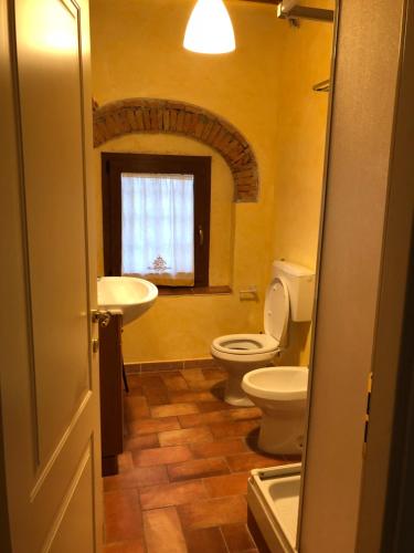 baño con lavabo y aseo y ventana en Poggio Savelli, en Scarperia
