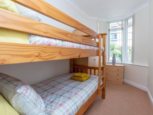 a bedroom with two bunk beds in a house at 7 Vista Apartments in Paignton