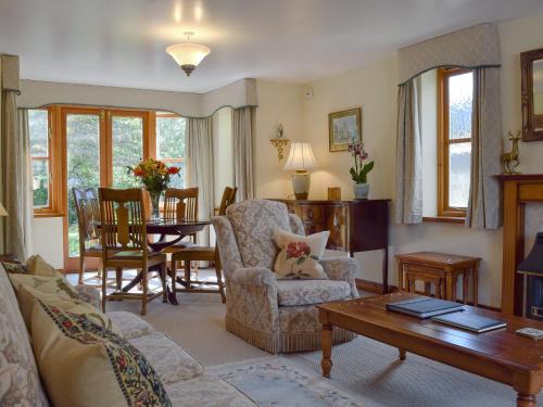 a living room with a couch and a table at Russet Cottage in Moreton in Marsh