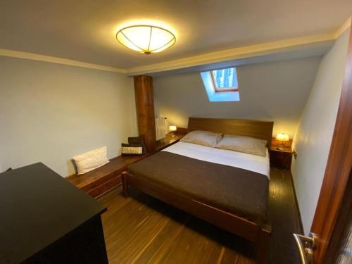 a bedroom with a bed and a desk and a window at Apartments 5 in the centre of Prague in Prague