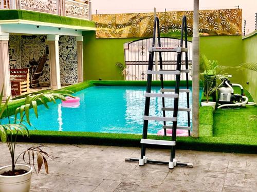 a ladder next to a swimming pool in a house at Spectacular 3/4-Bed-Apt With 24hrs Power And FAST Wi-Fi in Amuwo