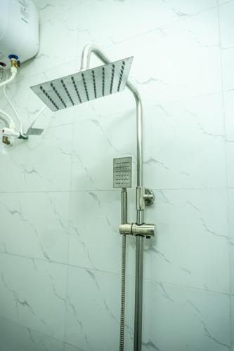 a shower in a bathroom with a sign on the wall at Spectacular 3/4-Bed-Apt With 24hrs Power And FAST Wi-Fi in Amuwo