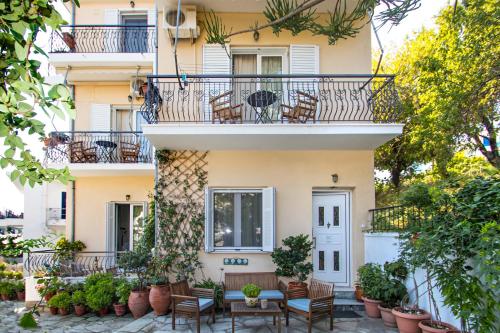 an apartment building with chairs and a balcony at Annis House in Skiathos
