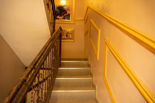 a flight of stairs with yellow railings in a building at Spectacular 3/4-Bed-Apt With 24hrs Power And FAST Wi-Fi in Amuwo