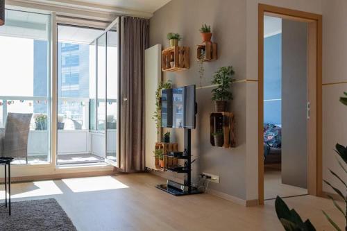 a living room with a tv and a large window at Modern place-Top Bratislava location in Bratislava