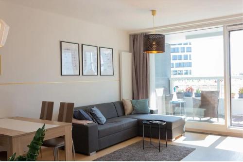 a living room with a couch and a table at Modern place-Top Bratislava location in Bratislava
