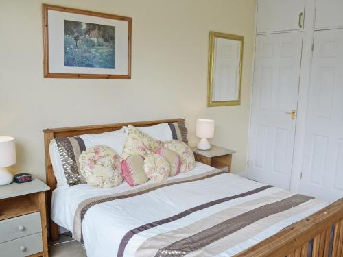 a bedroom with a bed with pillows on it at Waterside in Bowness-on-Windermere