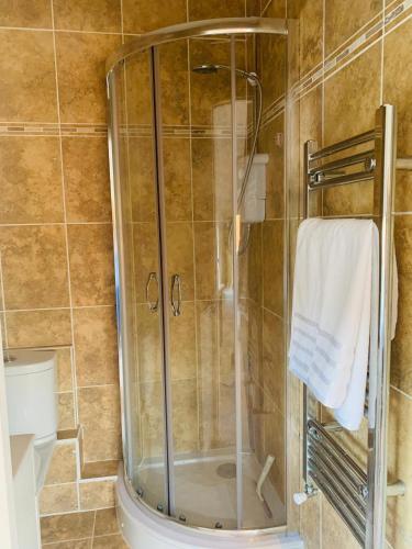 a shower with a glass door in a bathroom at Elegant 3BD Edwardian Home Warminster in Warminster