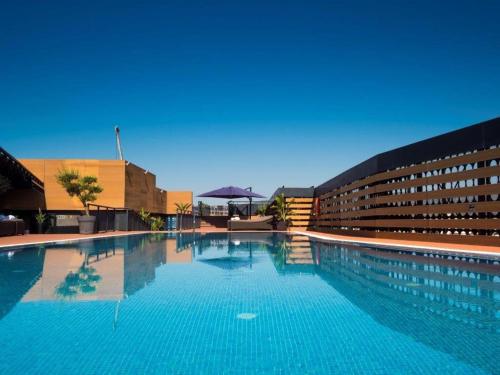 a large swimming pool in front of a building at Eurostars Palace in Córdoba