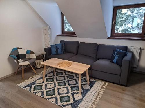 a living room with a couch and a table at BILÍKOVA CHATA - Horský hotel in Starý Smokovec