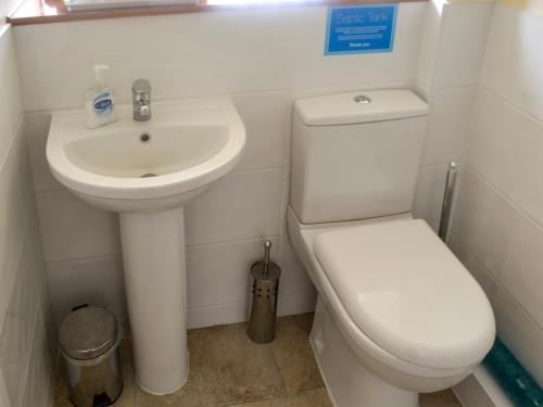 a bathroom with a white toilet and a sink at Clougha View - 29531 in Scotforth