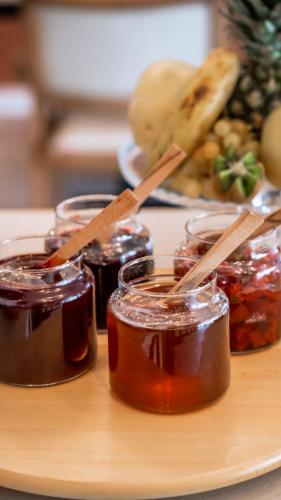 a table with jars of jam and a plate of food at Urla 1867 Hotel in Urla