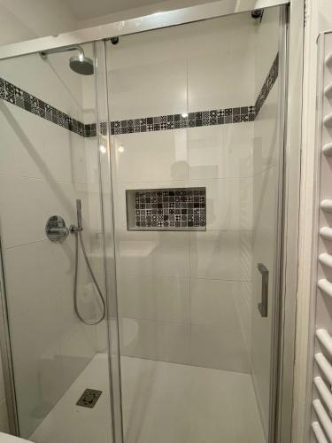 a shower with a glass door in a bathroom at San Valentino House in Bussolengo