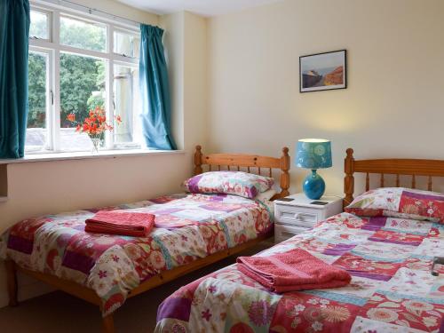 a bedroom with two beds and a window at Popehill Farm Apartment in Johnston