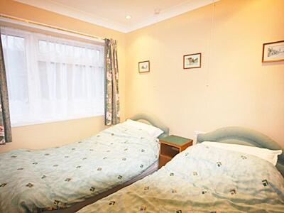 a bedroom with a bed and a window at Cliff End in Freshwater