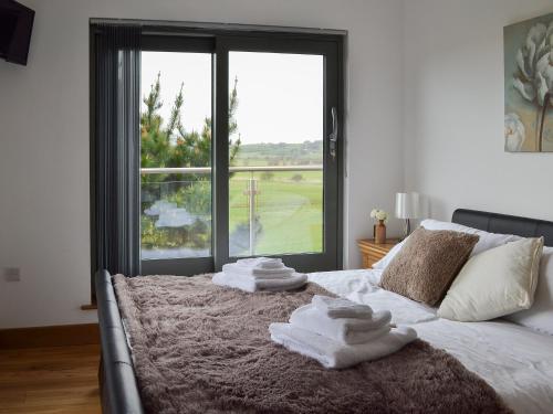 a bedroom with a bed with towels on it at Henry-oscar House in Winchelsea