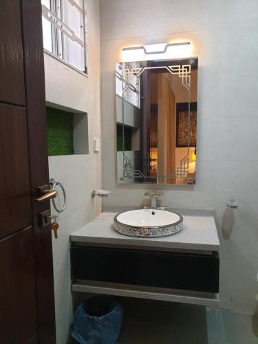 a bathroom with a sink and a mirror at White House Executive - Guest House Islamabad in Rawalpindi