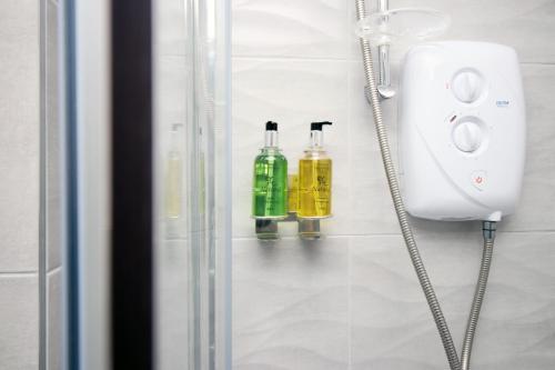 a bathroom with two bottles on a wall at Luxury City Loft Apartment! Great Location in Cardiff