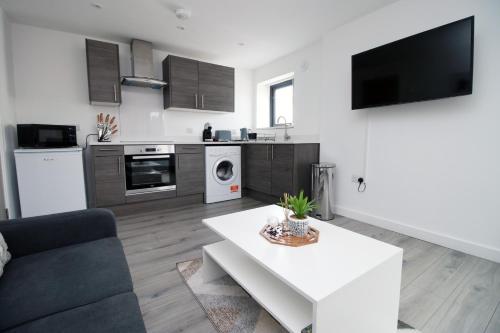 a living room with a couch and a table at Luxury City Loft Apartment! Great Location in Cardiff