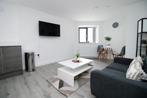 a living room with a couch and a table at Luxury City Loft Apartment! Great Location in Cardiff