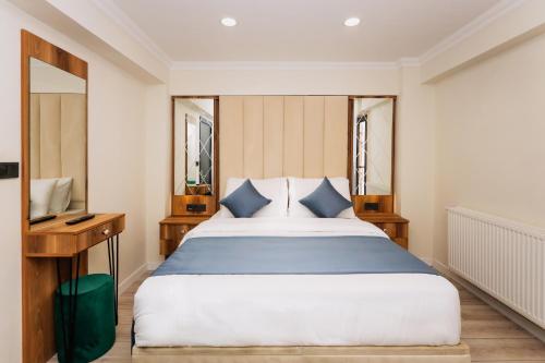 um quarto com uma cama grande e uma secretária em Galata Master Hotel em Istambul