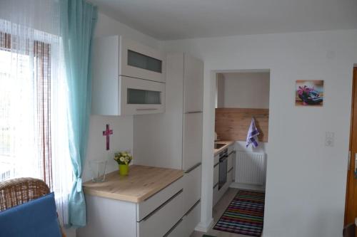 a kitchen with a counter and a cross on the wall at Familienferienwohnung Haus Praschberger in Ebbs