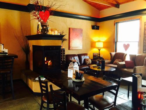 a living room with a table and a fireplace at Afton House Inn in Afton