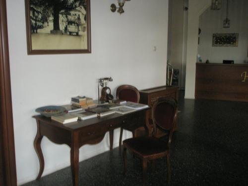 a room with a table with chairs and a telephone at Byzantion Hotel in Mystras