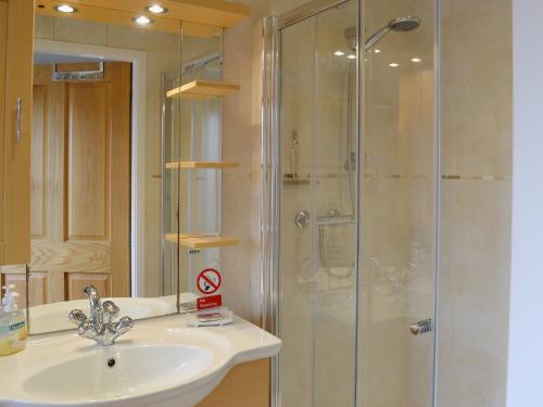 a bathroom with a sink and a shower at Stable Cottage in South Kilvington