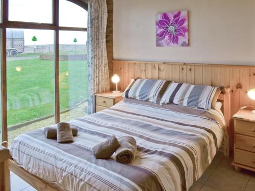 a bedroom with a large bed with two towels on it at Jenny Wren in Flamborough